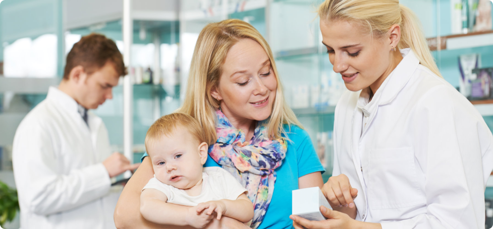 Customer holding her baby inside a pharmcy store